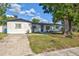 View of house with green grass and small trees at 321 Shore E Dr, Oldsmar, FL 34677