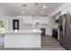 Bright kitchen features a large island, white cabinetry, stainless steel appliances, and modern lighting at 321 Shore E Dr, Oldsmar, FL 34677