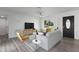 Bright living room featuring a modern ceiling fan, stylish furniture, and large window at 321 Shore E Dr, Oldsmar, FL 34677