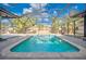 Relaxing screened pool area with blue water and lush landscaping for outdoor enjoyment at 321 Shore E Dr, Oldsmar, FL 34677