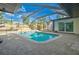 Beautiful screened-in pool area with a spacious deck, lush landscaping, and a serene backyard setting at 321 Shore E Dr, Oldsmar, FL 34677