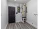 Utility room with water heater, electrical panel, painted walls, and wood-look vinyl flooring at 321 Shore E Dr, Oldsmar, FL 34677