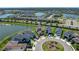 Aerial view of a two-story home on a cul-de-sac near a pond and road at 34135 White Fountain Ct, Wesley Chapel, FL 33545
