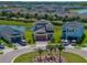 Aerial view of the property, showcasing its location near a pond and palm tree-lined streets at 34135 White Fountain Ct, Wesley Chapel, FL 33545