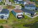 Aerial view of a single-Gathering home, lush green grass, and a screened in porch at 34135 White Fountain Ct, Wesley Chapel, FL 33545