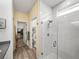 View of a bathroom with quartz countertops, walk-in shower, tile floor, and open access to the walk-in closet at 34135 White Fountain Ct, Wesley Chapel, FL 33545