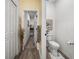 Bathroom featuring a walk-in closet, and a white toilet with wood-look floors at 34135 White Fountain Ct, Wesley Chapel, FL 33545