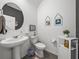 Charming half bathroom boasts a stylish pedestal sink and modern fixtures at 34135 White Fountain Ct, Wesley Chapel, FL 33545