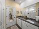 Modern bathroom featuring double sinks, quartz countertops, and a walk-in shower at 34135 White Fountain Ct, Wesley Chapel, FL 33545