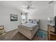 Comfortable bedroom featuring soft gray carpet, ceiling fan and blue bedding at 34135 White Fountain Ct, Wesley Chapel, FL 33545