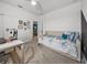 Versatile bedroom featuring a stylish desk, a daybed, neutral decor, offering flexible living space at 34135 White Fountain Ct, Wesley Chapel, FL 33545