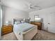 Bright bedroom with large bed, ceiling fan, dresser, and neutral-colored walls at 34135 White Fountain Ct, Wesley Chapel, FL 33545