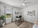 Bright bedroom featuring a stylish desk, neutral decor, ample light, and a modern ceiling fan, ideal for work or rest at 34135 White Fountain Ct, Wesley Chapel, FL 33545