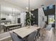 Modern dining room with unique lighting, decorative mirror, and stylish decor at 34135 White Fountain Ct, Wesley Chapel, FL 33545
