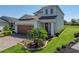 Beautiful two-story home with a brick paved driveway and a well-manicured lawn at 34135 White Fountain Ct, Wesley Chapel, FL 33545