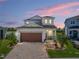 Beautiful two-story home featuring a brick paved driveway and a well-manicured lawn at 34135 White Fountain Ct, Wesley Chapel, FL 33545