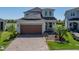 Charming two-story home with a well-kept lawn and brick paved driveway at 34135 White Fountain Ct, Wesley Chapel, FL 33545