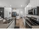 Modern kitchen featuring stainless steel appliances, a stylish island, and wood-look flooring at 34135 White Fountain Ct, Wesley Chapel, FL 33545