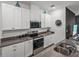 Modern kitchen with stainless steel appliances, ample cabinet space, and sleek countertops at 34135 White Fountain Ct, Wesley Chapel, FL 33545