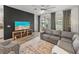 Living room features modern décor, a sliding glass door, and a ceiling fan at 34135 White Fountain Ct, Wesley Chapel, FL 33545