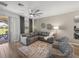 Living room showcasing a sliding glass door, modern decor, and a ceiling fan at 34135 White Fountain Ct, Wesley Chapel, FL 33545