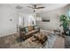 Upstairs living room with comfortable leather couch, wood coffee table, fan, and stylish decor at 34135 White Fountain Ct, Wesley Chapel, FL 33545