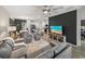 Spacious living room features modern decor, an open kitchen, and a ceiling fan at 34135 White Fountain Ct, Wesley Chapel, FL 33545