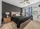 This main bedroom has plush carpet, a ceiling fan, natural light and a modern design at 34135 White Fountain Ct, Wesley Chapel, FL 33545