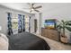 Comfortable main bedroom featuring a ceiling fan, and a modern dresser with a flatscreen TV at 34135 White Fountain Ct, Wesley Chapel, FL 33545