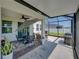 Relaxing screened-in patio with comfortable seating, outdoor dining, and lovely views of the backyard at 34135 White Fountain Ct, Wesley Chapel, FL 33545