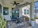 This covered patio offers a table, fan, and seating making it a relaxing area to enjoy the outdoors at 34135 White Fountain Ct, Wesley Chapel, FL 33545