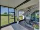 Enclosed patio boasting a dining table, umbrella, and relaxing view of the yard at 34135 White Fountain Ct, Wesley Chapel, FL 33545