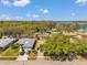 Aerial view of a neighborhood with tree-lined streets and lake views at 3957 Tarpon Pointe Cir, Palm Harbor, FL 34684