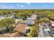 Aerial view of homes in a neighborhood surrounded by mature trees and a mix of roof styles at 3957 Tarpon Pointe Cir, Palm Harbor, FL 34684
