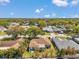 Aerial view of a charming neighborhood featuring mature trees, manicured lawns, and diverse home styles at 3957 Tarpon Pointe Cir, Palm Harbor, FL 34684