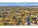 Scenic aerial view of the golf community featuring lush golf course, water views, and charming residences in a park-like setting at 3957 Tarpon Pointe Cir, Palm Harbor, FL 34684