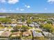 An aerial view showcases an established neighborhood with mature trees, well-kept homes, and manicured lawns at 3957 Tarpon Pointe Cir, Palm Harbor, FL 34684