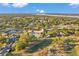 Aerial shot of the golf community highlighting a resort-style pool, tennis courts, clubhouse, manicured grounds and charming residences at 3957 Tarpon Pointe Cir, Palm Harbor, FL 34684
