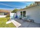 Cozy outdoor patio with seating, perfect for relaxing and enjoying the serene backyard ambiance at 3957 Tarpon Pointe Cir, Palm Harbor, FL 34684