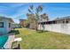 Expansive backyard with lush grass, mature trees, and a privacy fence providing a tranquil outdoor space at 3957 Tarpon Pointe Cir, Palm Harbor, FL 34684