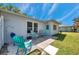 This backyard has a small patio area with chairs surrounded by lush greenery offering a peaceful outdoor retreat at 3957 Tarpon Pointe Cir, Palm Harbor, FL 34684