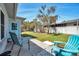 The backyard includes a small patio area with chairs and a view to the large manicured backyard space at 3957 Tarpon Pointe Cir, Palm Harbor, FL 34684