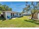Serene backyard featuring a well-maintained lawn, charming patio area, and vibrant landscaping for outdoor enjoyment at 3957 Tarpon Pointe Cir, Palm Harbor, FL 34684