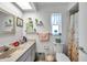 This bathroom features a vanity, a large mirror and decorative elements creating a bright and modern space at 3957 Tarpon Pointe Cir, Palm Harbor, FL 34684