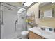 Bright bathroom with a glass-enclosed shower, skylight, and modern fixtures at 3957 Tarpon Pointe Cir, Palm Harbor, FL 34684