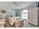 Charming bedroom features an arched window, light blue walls, and a comfortable bed at 3957 Tarpon Pointe Cir, Palm Harbor, FL 34684