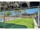 View of the community bocce ball court area with spectator seating and fan at 3957 Tarpon Pointe Cir, Palm Harbor, FL 34684