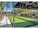 View of the community bocce ball court with covered seating and pool view at 3957 Tarpon Pointe Cir, Palm Harbor, FL 34684