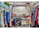 This closet features ample storage shelves and hanging rods making it easy to organize your wardrobe and accessories at 3957 Tarpon Pointe Cir, Palm Harbor, FL 34684