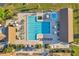 Aerial view of a community pool area featuring a pool, jacuzzi, lounge chairs, and cabanas at 3957 Tarpon Pointe Cir, Palm Harbor, FL 34684